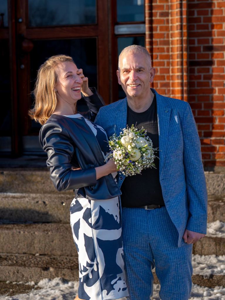 Newly married couple outside Danish town hall after wedding ceremony